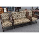 A late 19th or early 20th Century three piece lounge suite having oak twist frae, bergere cane sides