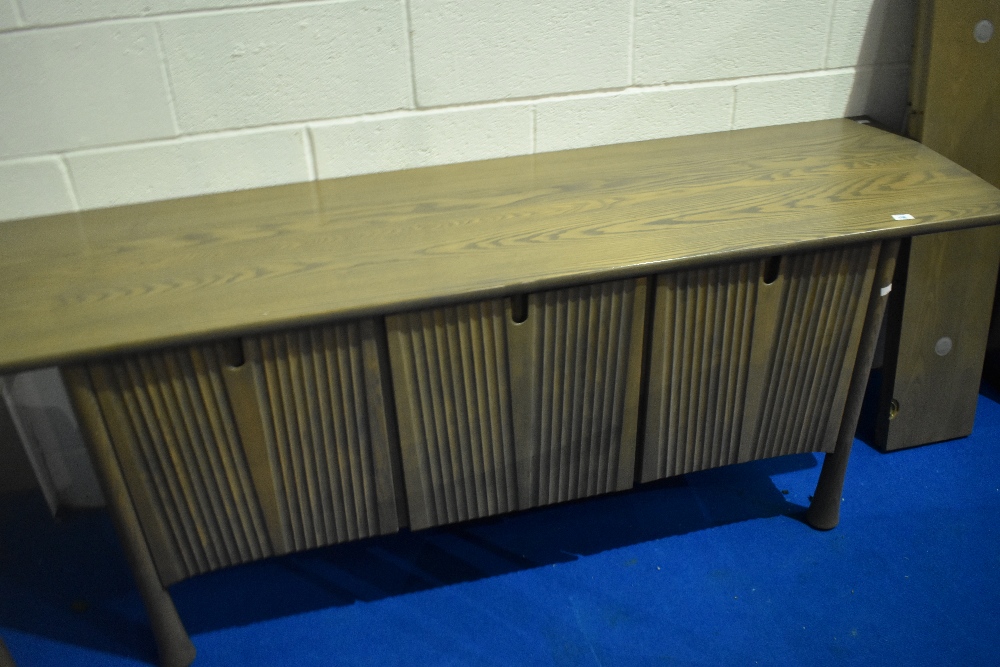 A modern bespoke Ercol sideboard, Silver mist design, with slide out cocktail section to centre,