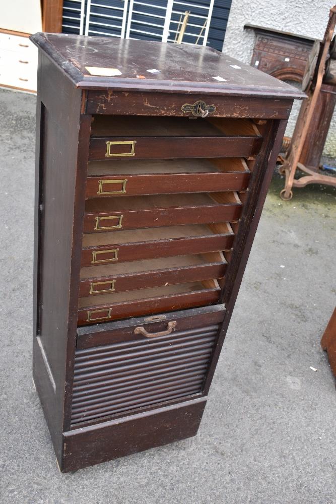 A vintage office cabinet having tambour top, stamped Wolfe