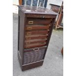 A vintage office cabinet having tambour top, stamped Wolfe