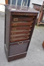 A vintage office cabinet having tambour top, stamped Wolfe