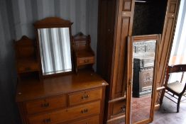 A Victorian two piece bedroom suite comprising mirror door wardrobe and dressing table