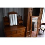 A Victorian two piece bedroom suite comprising mirror door wardrobe and dressing table