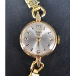 A lady's 1970's yellow metal wristwatch by Tudor having baton & Arabic numeral dial to champagne