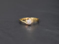A diamond solitaire ring, approx 0.25ct in a collared mount to cross over shoulders on a yellow