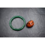 A vintage green glass bangle (with old repair) and a rough cut (polished) Baltic Amber pendant, no