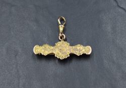 A Victorian 9ct gold watch bar brooch with suspended clasp and embossed decoration, approx 3.8g