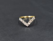 A nine stone diamond set wish bone ring, total approx 0.5ct on an 18ct gold loop, size P & approx