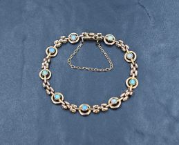 A Victorian 9ct rose gold bracelet having collet set opals in circular links with gold brick