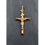 A 9ct gold crucifix pendant, approx 35mm long, 40mm with loop and 1.6g