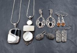 A collection of silver jewellery including two pairs of marcasite set drop earrings with floral