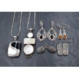 A collection of silver jewellery including two pairs of marcasite set drop earrings with floral