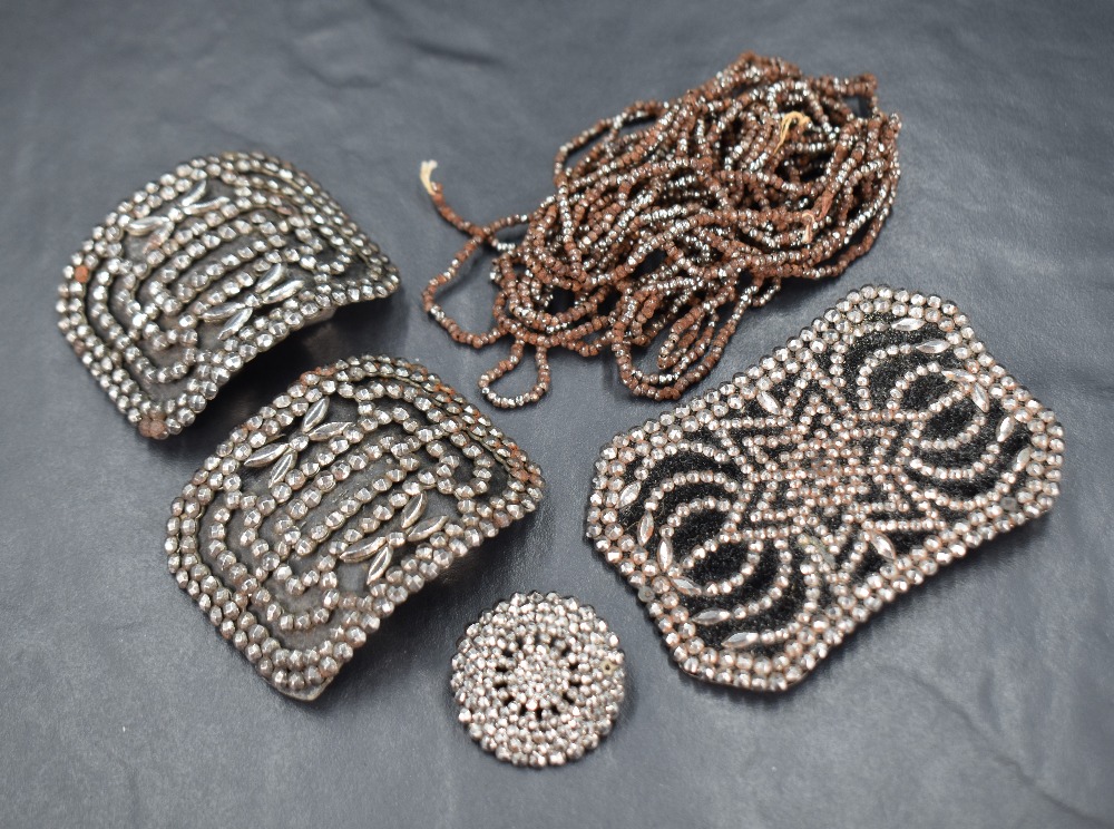 A small selection of cut steel including belt buckle, shoe buckles, button and chain