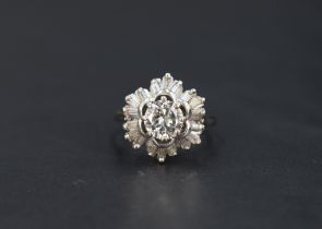 An open diamond cluster ring having a central brilliant cut diamond, approx 1ct within a frilled