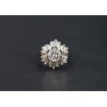 An open diamond cluster ring having a central brilliant cut diamond, approx 1ct within a frilled