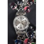 A Swatch watch no:#814 having Arabic numeral and dot dial to silvered face and chain bracelet with