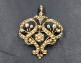 An Edwardian yellow metal brooch/pendant stamped 15ct having extensive seed pearl decoration, approx