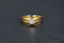 A gent's 9ct gold signet ring having a small inset diamond chip to raised shoulders, size U & approx