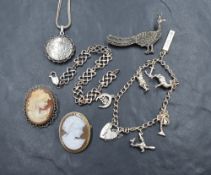 A small selection of silver jewellery including two cameo brooches, a small charm bracelet,