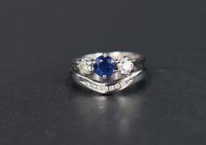 A sapphire and diamond trilogy ring, the central round cut sapphire approx. 0.33cts flanked by two