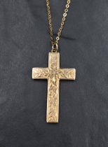 An Edwardian 9ct rose gold cross and chain having floral and foliate engraved decoration, chain