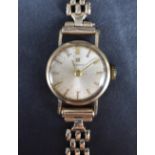 A lady's vintage 9ct gold wrist watch by Tissot having a baton numeral dial to champagne coloured