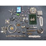 A selection of silver and white metal jewellery including charms, brooches, chains, rings, necklaces