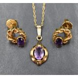 A 9ct gold and amethyst pendant with matched stud earrings having collared stones and twist gold