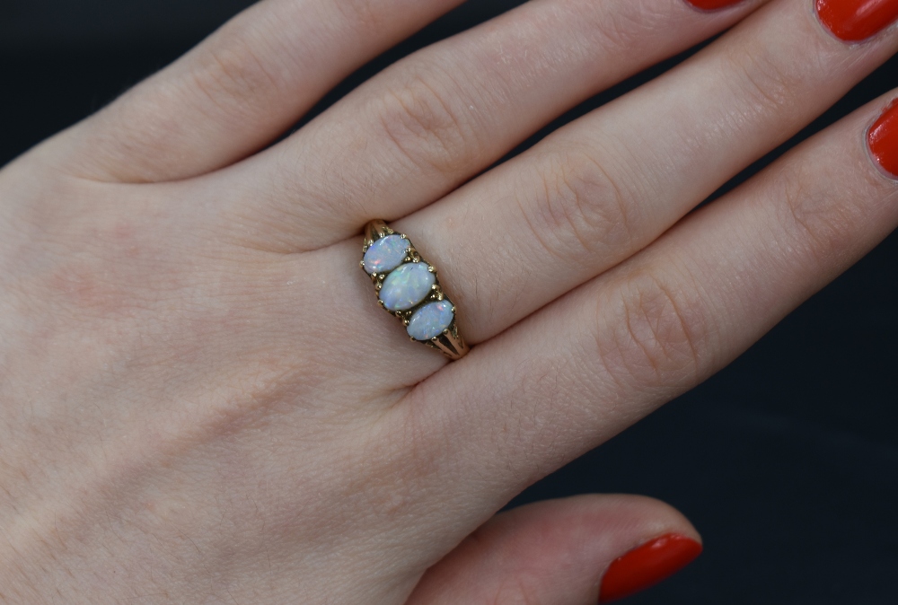 An opal trio ring having three opals in a gallery mount on a 9ct gold loop, size P & approx 2.5g - Image 3 of 3