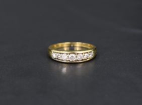 A diamond half eternity ring having seven diamonds in a channel setting on an 18ct gold loop, size O