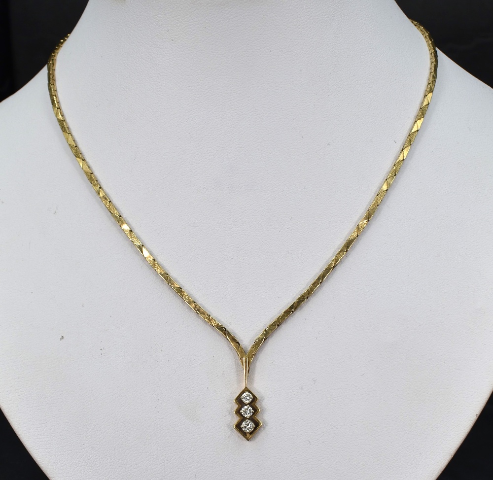 A 9ct gold necklace having three stone diamond drop, total approx 0.192ct in an open mount, with - Image 2 of 2