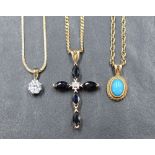 A collection of three pendants with chains comprising a 9ct gold sapphire and diamond cross on a 9ct