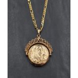 A 9ct gold spinning locket having floral motif engraving with a decorative rope-work frame, on a 9ct