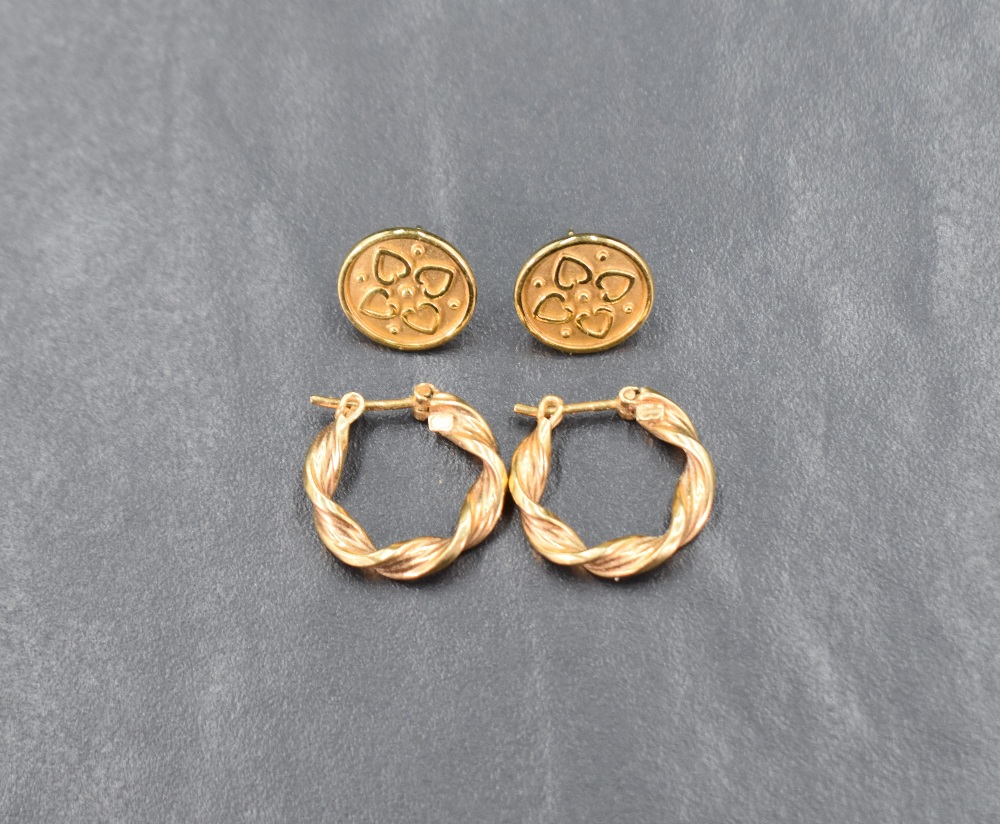 Two pairs of 9ct gold earrings, one of twist loop form the other of decorative disc form, approx 3.