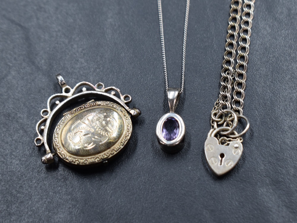 A collection of silver jewellery comprising a bezel set amethyst pendant on a silver curb link