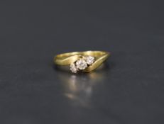 A diamond trilogy ring, the graduated diamonds with twist shoulders on an 18ct gold shank, ring size