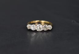 A five stone graduated old cut diamond ring, total approx 1.25ct in a claw set mount on a yellow