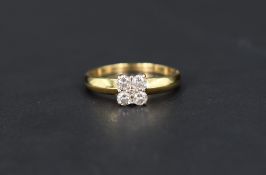 A four stone diamond square set ring having a central diamond chip,total approx 0.50ct, all in a