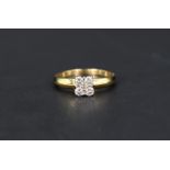 A four stone diamond square set ring having a central diamond chip,total approx 0.50ct, all in a