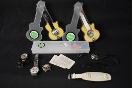 Two Beatles themed fashion wrist watches having decorative themed faces in plastic guitar shaped
