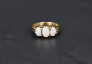 An opal trio ring having three opals in a gallery mount on a 9ct gold loop, size P & approx 2.5g