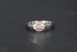 A small nine diamond cluster ring having a stepped mount on a 9ct gold loop, size P 7 approx 2.3g