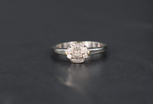 A small nine diamond cluster ring having a stepped mount on a 9ct gold loop, size P 7 approx 2.3g