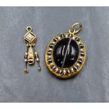 A Victorian gold hair locket having a banded agate cabochon to front within a surround of split