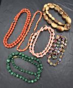 A selection of six beaded necklaces comprising coral examples, malachite, horn and Murano style