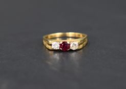 A diamond and ruby trilogy ring having three equal stones, each approx 0.128ct in a claw set mount