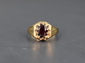 A gent's 9ct gold signet ring having a gypsy set oval garnet, size S & 5.8g
