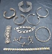 A selection of silver and white metal bracelets and bangles including filligree, torque etc,