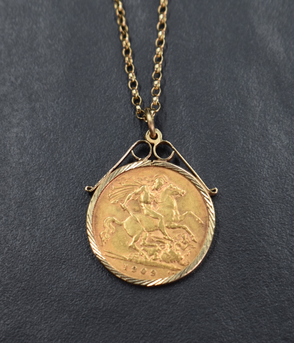 A gold half sovereign dated 1909 in a 9ct gold removable decorative pendant mount on a 9ct gold