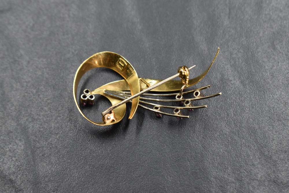An 18ct gold spray design brooch, having a ribbon motif set with eight round cut rubies, approx 5. - Image 2 of 2